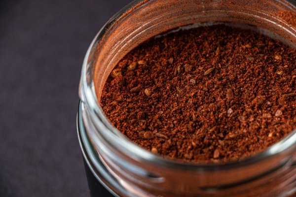 Close-up of spice rub clumping in a glass jar